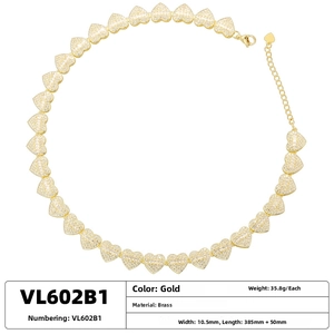 Detailed close-up of gold brass heart necklace with clear cubic zirconia insets
