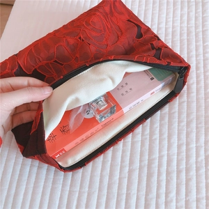 Macro view showing large 3D floral lace embroidery and spacious canvas interior lining