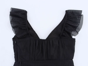 Close-up of black V-neck mesh dress with ruffle sleeves and detailed herringbone texture