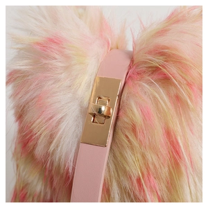 Detail of pink and beige faux fur texture with golden metal buckle and leather strap