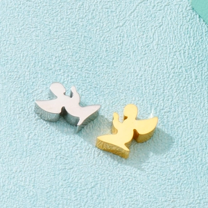 Detail view of gold and silver angel-shaped pendants for jewelry making on blue background