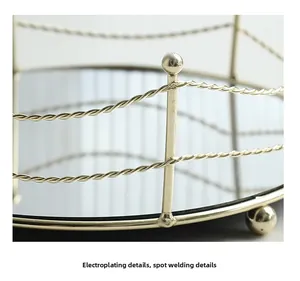 Detail of the golden electroplated rope metal fence and spot welding on mirror tray