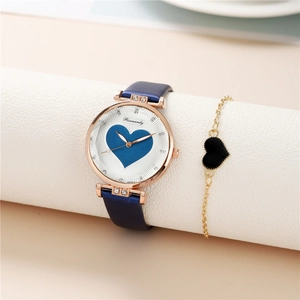 Detail of rose gold watch with blue heart dial and matching heart charm bracelet