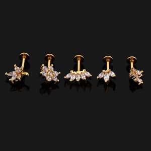 Detailed view of five gold-plated 16G flat back ear studs with sparkling clear zircons