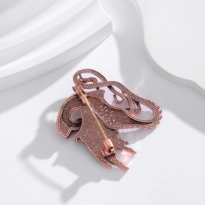 Back view of vintage rose gold flamingo brooch with pink enamel on white background