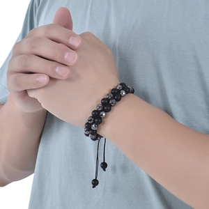 Detail of double-layer hematite and tiger eye beaded bracelet with adjustable cord