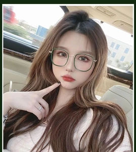 Close-up of stylish retro green square frames with gold metal temples worn by a model