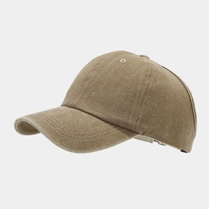 Close-up of the washed khaki canvas texture and stitching on a classic baseball cap