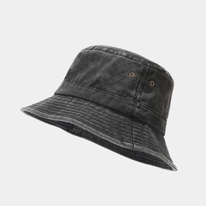 Detail view of washed denim bucket hat featuring vintage brass ventilation eyelets