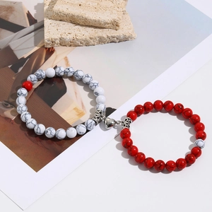 Detail of marble pattern beads and heart magnetic clasp on couple's bracelet set