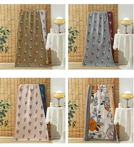 Detail of four-layer cotton gauze towels in plaid and floral patterns for home use