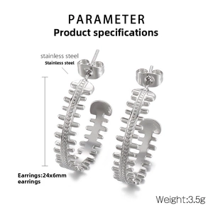 Detail shot of C-shaped silver stainless steel earrings with unique gear texture