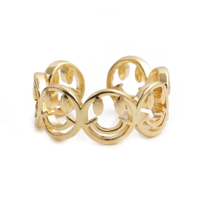 Close-up of golden smiley face hollowed-out pattern on adjustable copper ring