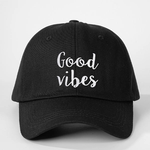 Detailed view of Good Vibes embroidery on a vintage adjustable black cotton baseball cap