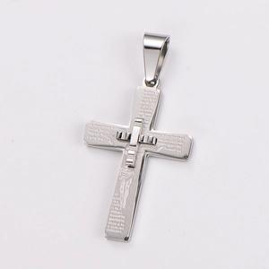Detail of cross pendant featuring engraved Spanish Lord's Prayer and Jesus figure