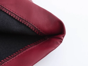 Gros plan sur la texture du cuir rouge avec des détails de coutures noires contrastées
