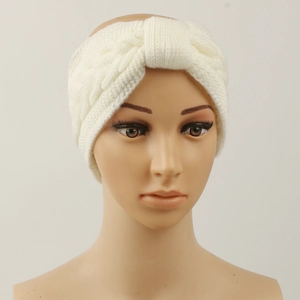 Detail of white cable knit winter headband showing soft texture and twisted braid pattern