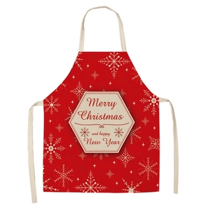Detail of red Christmas apron featuring white snowflakes and Merry Christmas text