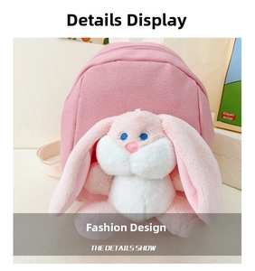 Close-up of pink canvas backpack featuring a plush long-eared rabbit doll decoration