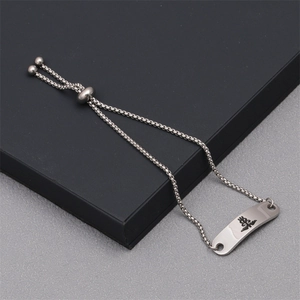 Detailed close-up of adjustable titanium steel bracelet with engraved leopard totem plaque
