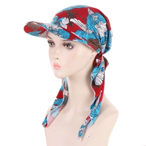 Detail of floral pattern headscarf cap with red fabric and blue flowers on model