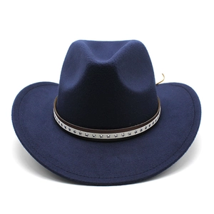 Detail of navy blue felt cowboy hat featuring vintage brown band with silver star rivets