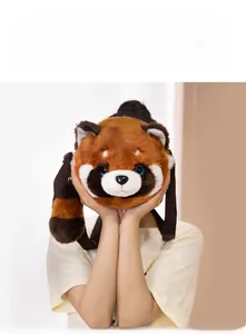 Detail of red panda plush crossbody bag with fluffy faux fur and striped long tail