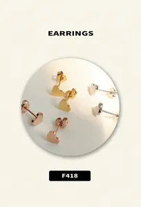 Detailed view of heart-shaped metal stud earrings in gold, silver and rose gold finishes