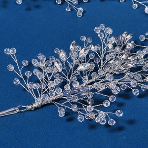 Macro view of handmade silver bridal headpiece with crystal beads and branch design