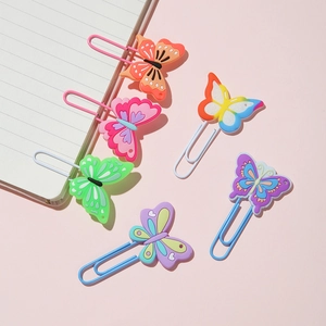 Five colorful PVC butterfly paper clips on a pink background for office and gift sets