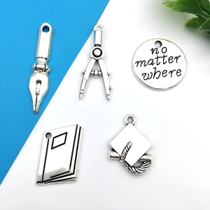 Silver alloy graduation charms set with pen, compass, book and doctoral hat designs