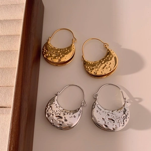 Minimalist geometric crescent earrings with textured lava finish in gold and silver