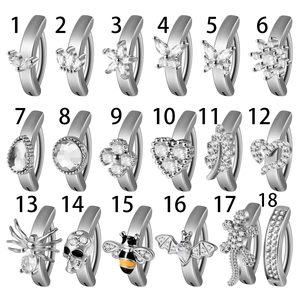 Grid view of 18 stainless steel belly rings with butterfly, flower and zircon details