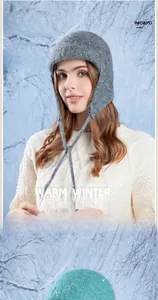 Detailed knit texture of a warm winter earflap hat with long ties and soft wool fabric