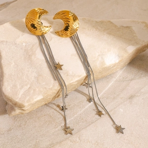 Star tassel earrings in gold and silver finish displayed on natural stone background