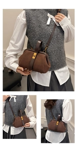 Close-up of vintage brown suede shell bag featuring gold clasp and dark PU leather handle