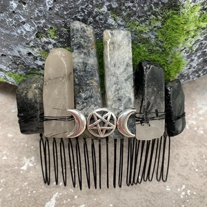 Macro shot of natural crystal hair comb featuring a silver triple moon pentagram detail