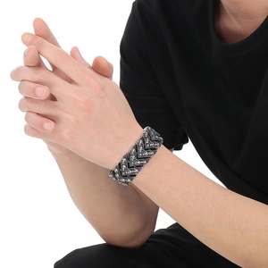 Detail of vintage punk skull bracelet with V-shaped links and gothic relief in dark steel
