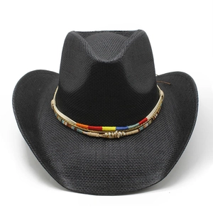 Macro detail of black straw cowboy hat with a colorful ethnic braided band and shell