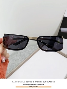 Detail showing vintage rectangular sunglasses with silver rivets and gold metal bridge