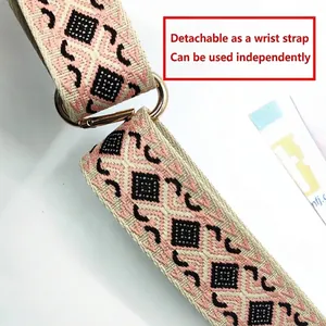 Adjustable woven phone strap with pink geometric pattern and gold ring clasp