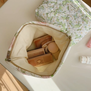 Quilted floral cotton makeup bag in cream with green flower patterns and metal zipper
