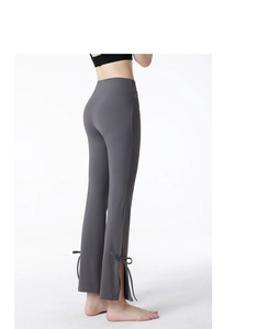 Close-up of high-waist yoga pants featuring side slit hem and decorative bow details
