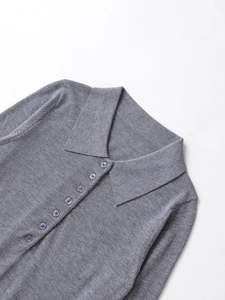 Detailed view of grey knit polo cardigan featuring classic collar and button placket