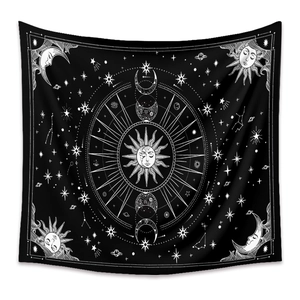 Close-up of black and white mandala tapestry featuring sun, moon, and star patterns