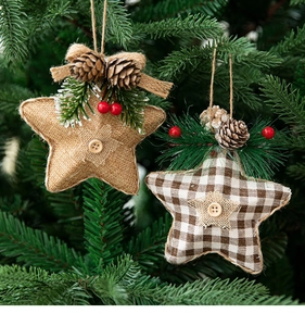 Detail of burlap star ornaments with pine cones and berries on a Christmas tree