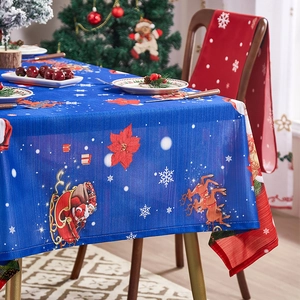 Blue Christmas tablecloth featuring Santa's sleigh and reindeer in festive home setting