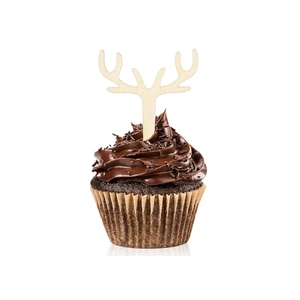 Close-up of wooden reindeer antler cupcake toppers on a chocolate cake for Christmas