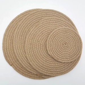 Detailed top view of natural jute placemats with woven spiral texture and round shape