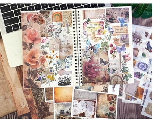 Flat lay of vintage scrapbooking paper set with floral, plant, and butterfly stickers